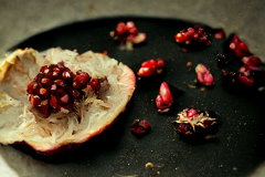 Pomegranate on black plate